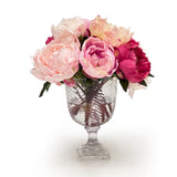 Clear glass vase with pink flowers on a white background