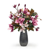 Bouquet of pink and white Magnolia flowers in a textured gray vase on a white background