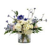Luxury faux delphinium and hydrangea floral arrangement in clear cut glass vase with blue and white blooms
