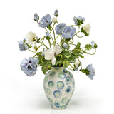 Blue and beige poppy arrangement in a decorative swirl porcelain vase