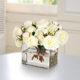 White faux rose arrangement in a modern clear rectangle glass vase