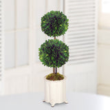 Double ball faux topiary arrangement in a decorative cream canister vase