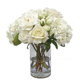 Real Touch rose and lisianthus faux floral arrangement in clear glass vase with ivory blooms