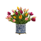 Colourful faux mixed tulip arrangement displayed in a decorative blue and white porcelain style planter