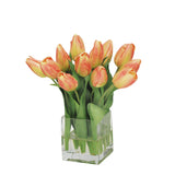 Orange tulip arrangement in a clear glass cube vase