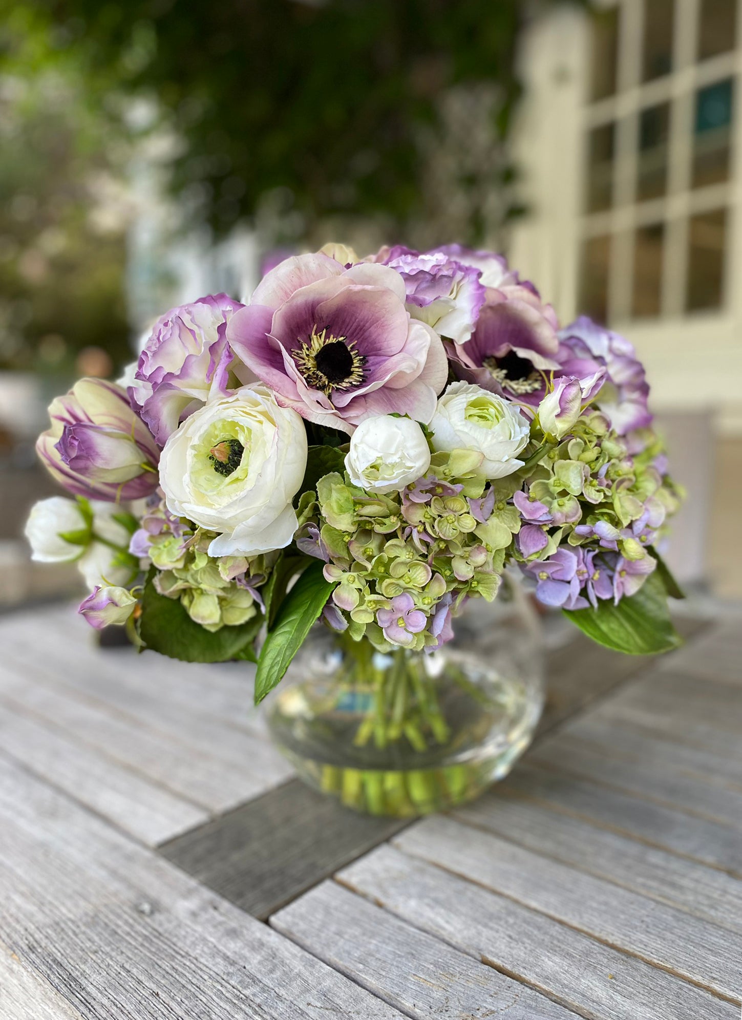 Purple and white faux floral tabletop centerpiece