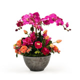 Orchid Tulip floral arrangement in a gray bowl on a white background