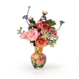 Colorful rose arrangement in a multicolored vase on a white background