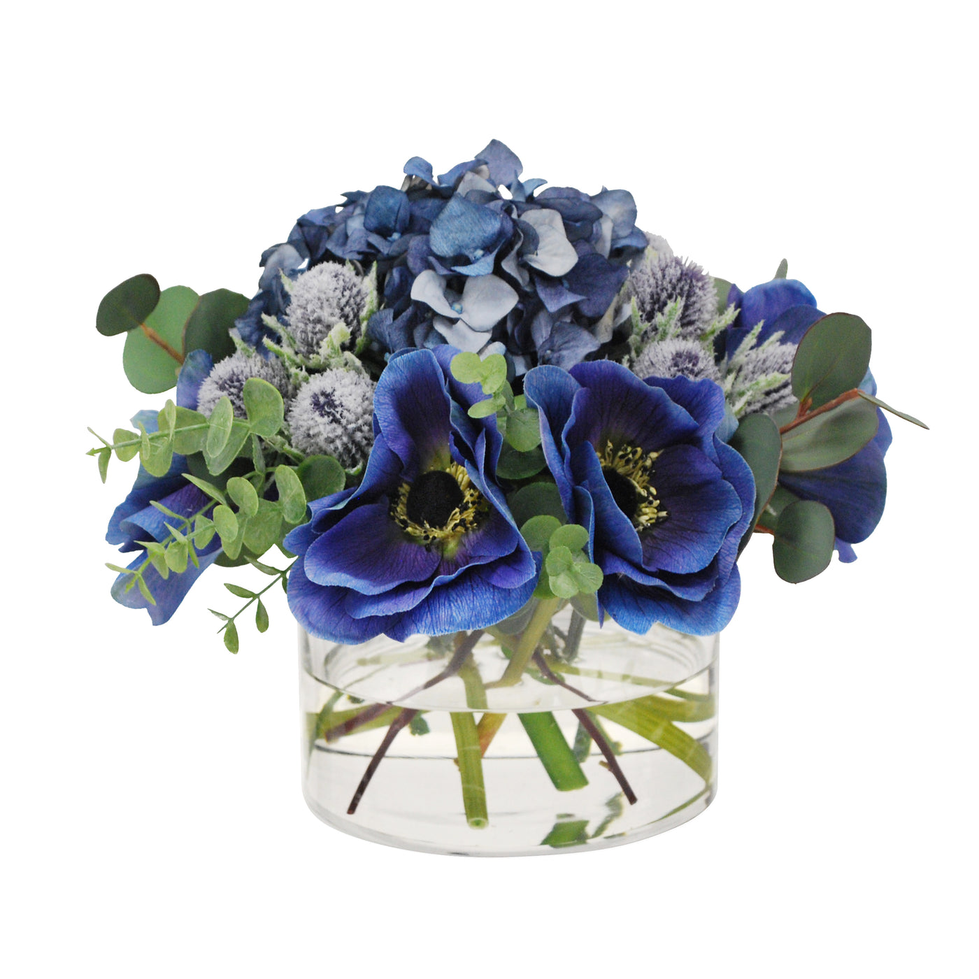 small faux flower arrangement in glass with blue anemone and hydrangea