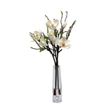 Lifelike white tree magnolia arrangement with natural branches in a tall clear glass vase