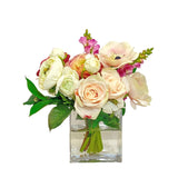 Compact blush toned faux mixed floral arrangement in cube glass vase for desks, shelves, and modern home décor