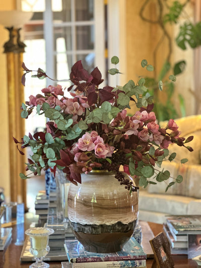 High-end faux orchid cymbidium floral arrangement in hand-painted porcelain vase for Fall and Autumn in a living room