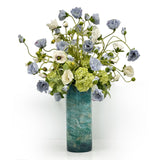 luxury faux poppies arranged naturally in a blue painters cylinder vase