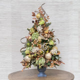 luxury pre-decorated Christmas tree with green and gold ornaments and decor
