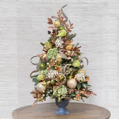 luxury pre-decorated Christmas tree with green and gold ornaments and decor