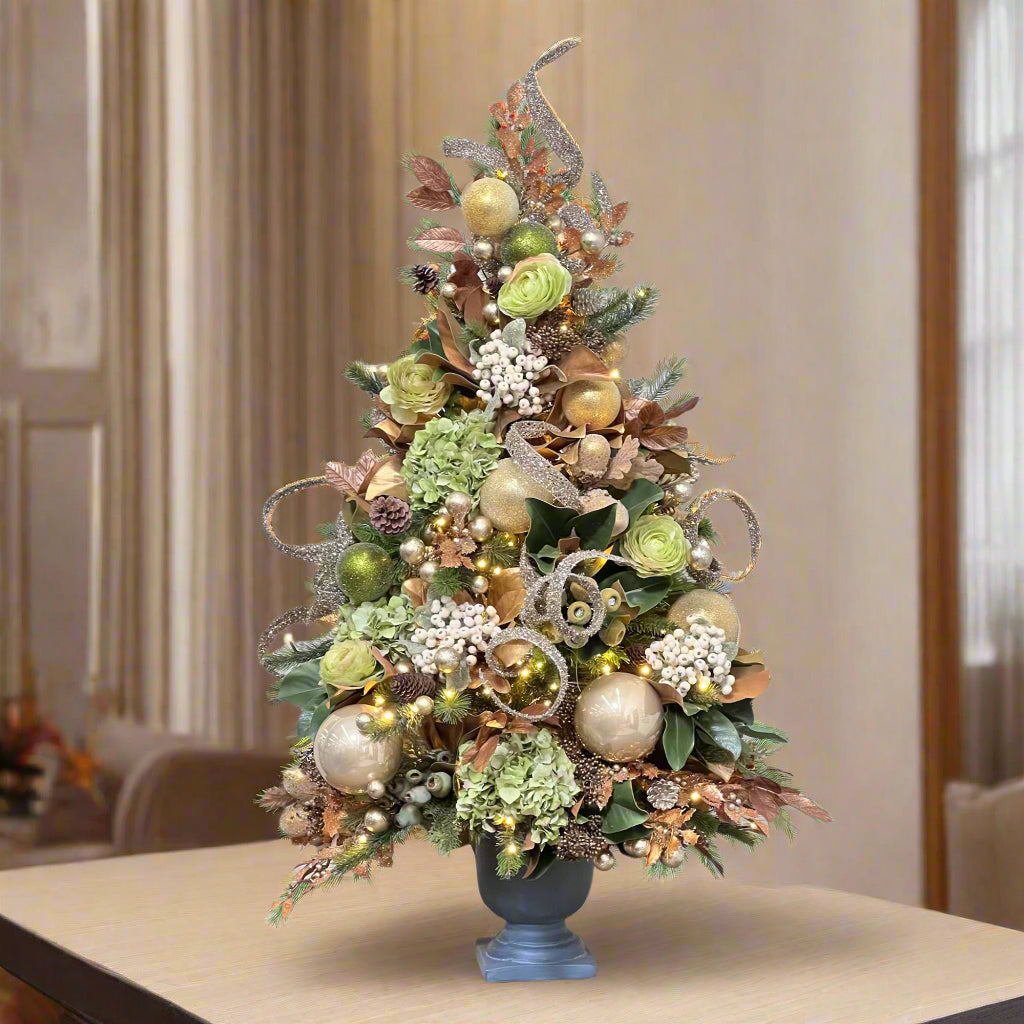 luxury tabletop pre-decorated Christmas tree with green and gold ornaments and decor