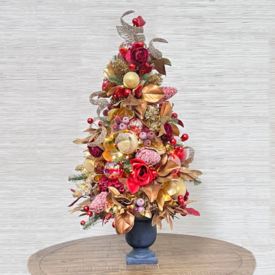 luxury pre-decorated tabletop Christmas tree pre-strung with lights, ornaments, flowers, berries, and more.