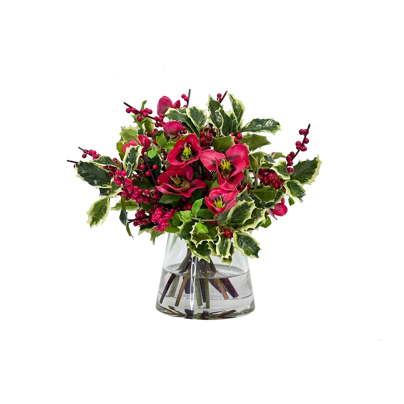 Hand-crafted hellebores, red berries, and greenery in a glass cylinder vase, displayed against a white background