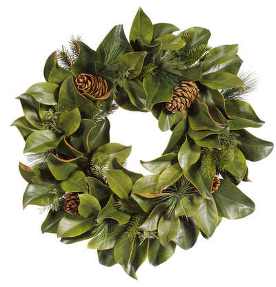 Hand-crafted magnolia leaf and mixed pine wreath with green accents, displayed against a white background