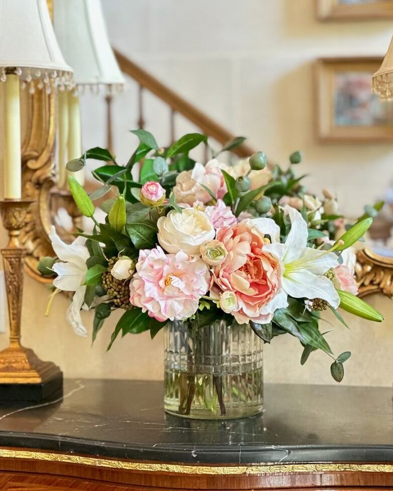Pink and cream floral arrangement on a console table