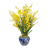 Yellow faux oncidium orchid arrangement in a blue and white ceramic bowl vase